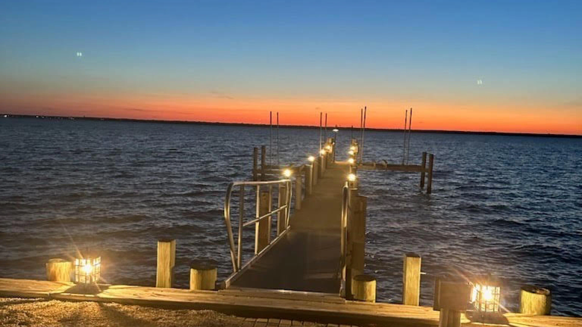 dock with a sunrise and some lights around